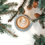 Cup of coffee with pine branches